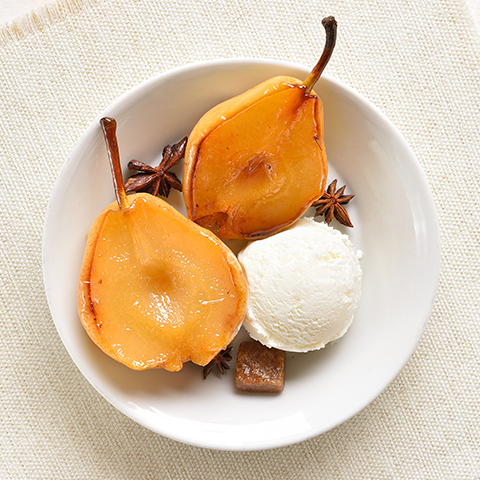 Image of poached pear dessert with ice cream. 