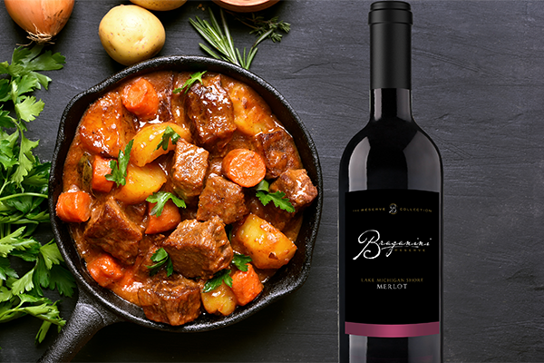 Image of Braganini Reserve Merlot wine and beef stew. 
