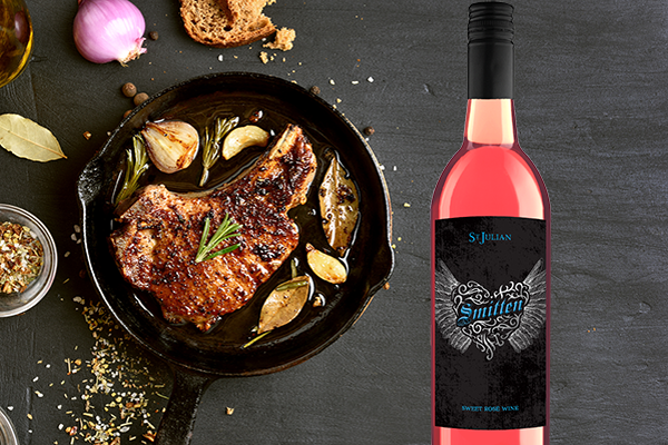 Image of Smitten rose wine with pork chop in a pan cooking. 